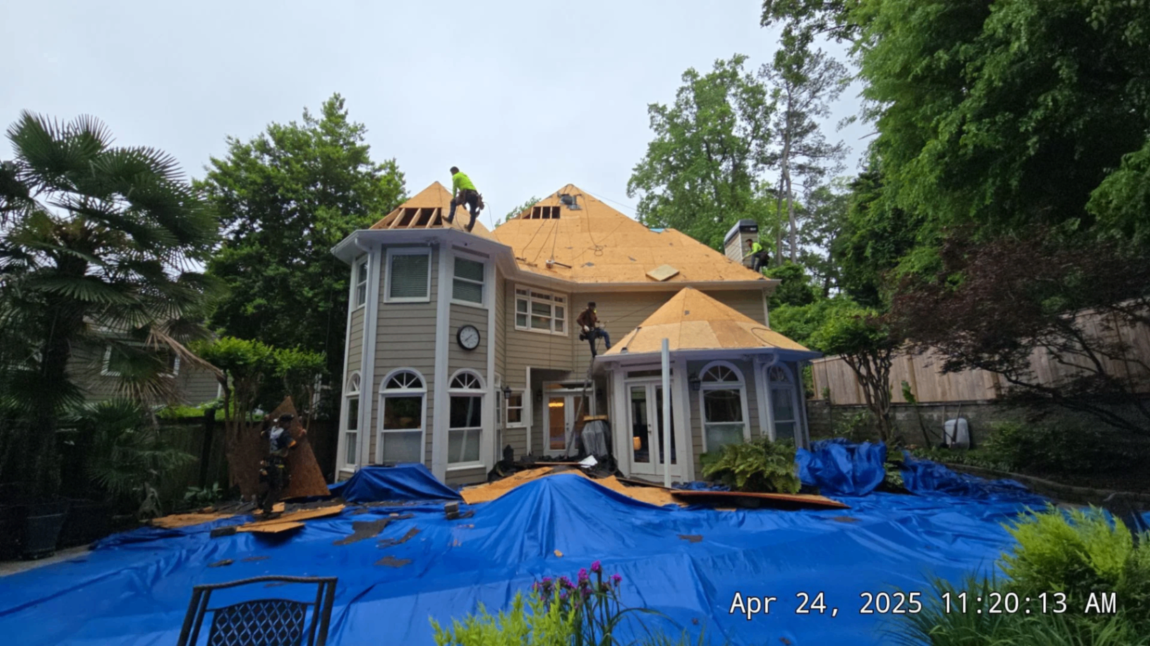 Full tear-off in progress with new decking and property fully tarped for protection