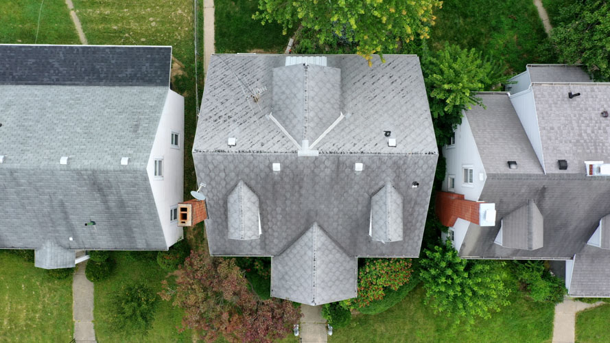 Overhead view of a home before and after a new shingle roof — before
